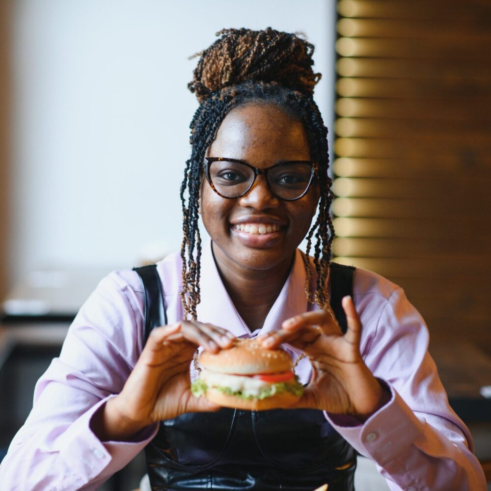 https://stspkg.com/wp-content/uploads/2025/05/Woman-eating-burger-scaled-e1746199192299.jpg
